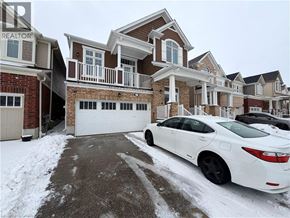 Kitchener apartment for rent - A white car is parked in front of a house with a snow-covered driveway.