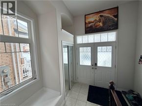 Kitchener apartment for rent - A room with a large window and a painting of a tiger on the wall.