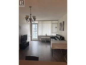 Richmond apartment for rent - A living room with a couch, a television, and a chandelier.