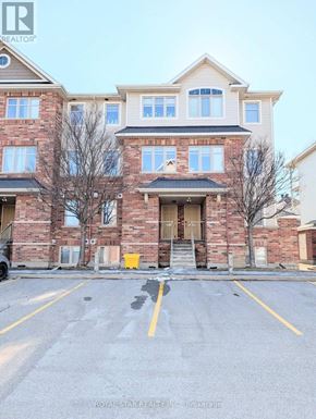 Ottawa condo for rent - A building with a parking lot in front of it.