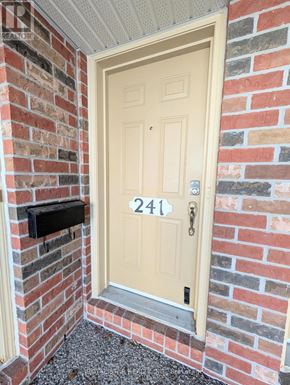 Ottawa condo for rent - A white door with the number 241 on it.
