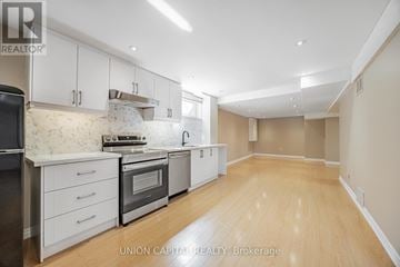 Markham (Aileen-Willowbrook) apartment for rent - A kitchen with white cabinets and wooden floors.