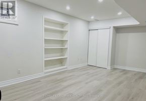 Markham (Raymerville) apartment for rent - A room with white walls and wooden flooring, with a sign that reads "REALTOR" on the wall.