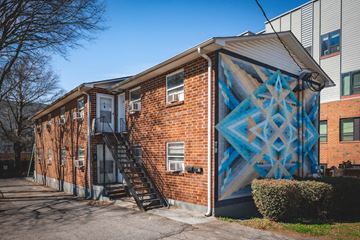 Atlanta apartment for rent - A brick building with a blue geometric mural on the side.