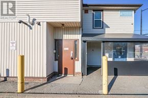 Niagara-On-The-Lake (Town) apartment for rent - A building with a brown door and a sign that says "REALTOR".
