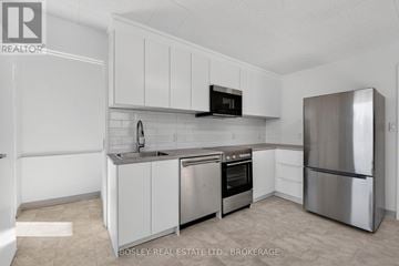Niagara-On-The-Lake (Town) apartment for rent - A kitchen with white cabinets and stainless steel appliances.