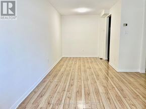 Toronto (Don Valley Village) townhouse for rent - A room with wooden flooring and white walls.