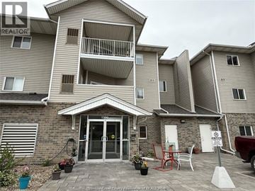 Windsor condo for rent - A two-story apartment building with a balcony on the second floor.