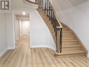 Markham (Village Green-South Unionville) apartment for rent - A wooden staircase with a black railing in a white room.