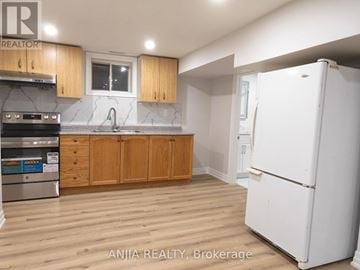 Markham (Village Green-South Unionville) apartment for rent - A kitchen with wooden cabinets and a white refrigerator.