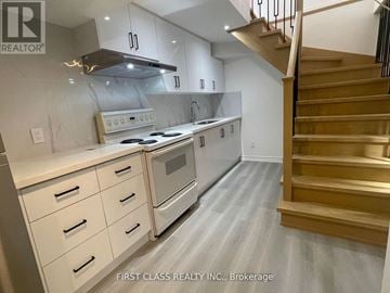 Markham (Markville) apartment for rent - A modern kitchen with a stainless steel oven and wooden staircase.