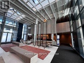 Vaughan (Vaughan Corporate Centre) condo for rent - A modern living room with a red carpet and a glass ceiling.