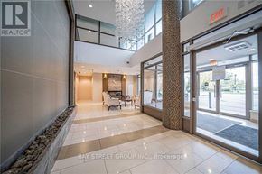 Richmond Hill (Beaver Creek Business Park) condo for rent - A lobby with a glass wall and a chandelier.