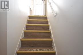 Newmarket (Bristol-London) apartment for rent - A staircase with wooden steps and yellow handrails.