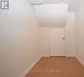 Newmarket (Bristol-London) apartment for rent - A white door is in a room with wooden floors and white walls.