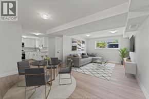 Windsor apartment for rent - A well-lit, modern living room with a kitchen area in the background.