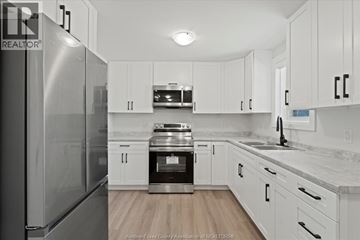 Windsor apartment for rent - A kitchen with white cabinets and a stainless steel refrigerator.