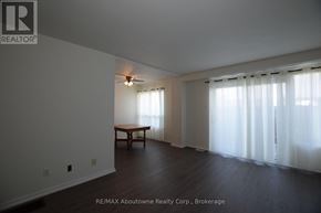 Brantford multi-family for rent - A room with a table and a window with curtains.