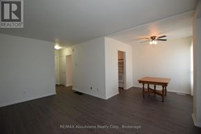 Brantford multi-family for rent - A room with a table and a ceiling fan.