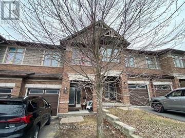 Ottawa townhouse for rent - A house with a tree in front and cars parked in front of it.