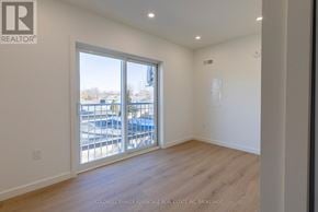 Port Colborne (Sugarloaf) multi-family for rent - A room with a sliding glass door leading to a balcony.