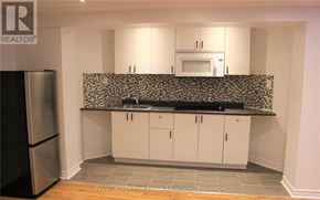 Vaughan (Vellore Village) apartment for rent - A kitchen with white cabinets and a black and white backsplash.