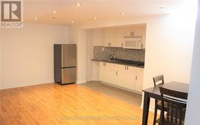 Vaughan (Vellore Village) apartment for rent - A kitchen with a refrigerator, cabinets, and a table.