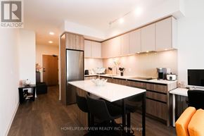 Vaughan (Beverley Glen) condo for rent - A kitchen with wooden cabinets and a countertop is shown.