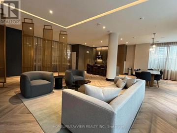 Vaughan (Beverley Glen) condo for rent - A living room with a grey sofa and a black table.