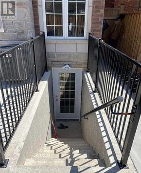 Halton Hills (Georgetown) apartment for rent - A man is standing outside a doorway with a window above it.