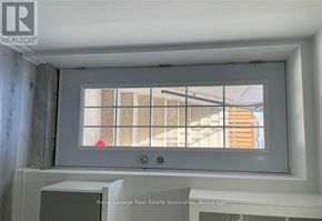 Halton Hills (Georgetown) apartment for rent - A window with a white frame and a view of a building outside.