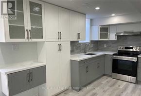 Halton Hills (Georgetown) apartment for rent - A kitchen with white cabinets and a stainless steel oven.