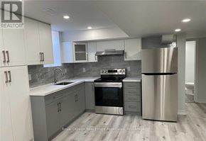 Halton Hills (Georgetown) apartment for rent - A modern kitchen with stainless steel appliances and white cabinets.