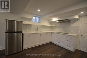 Milton (Fo Ford) apartment for rent - A modern kitchen with white cabinets and a stainless steel refrigerator.