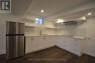 Milton (Fo Ford) apartment for rent - A modern kitchen with white cabinets and a stainless steel refrigerator.