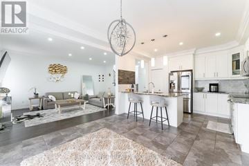 Cambridge apartment for rent - A modern kitchen and living room with a large rug on the floor.