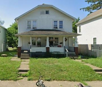 Columbus apartment for rent - A white house with a porch and a bicycle in front.