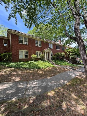 Atlanta apartment for rent - A red brick house with a white door and windows.