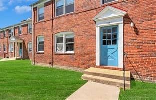 Essex apartment for rent - A red brick building with a blue door and a small porch.
