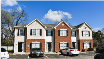 Orangeburg apartment for rent - A two-story brick house with a white car parked in front.