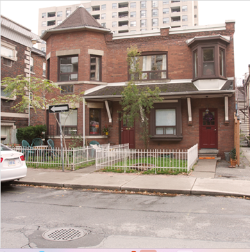 Toronto apartment for rent - A red brick house with a white picket fence in front.