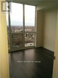 Toronto (Willowdale East) condo for rent - A room with a view of the city through a large window.