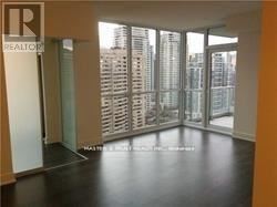 Toronto (Willowdale East) condo for rent - A realtor sign is on the door of a large empty room.