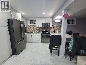 Windsor apartment for rent - A kitchen with a refrigerator, microwave, oven, and cabinets.