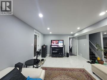 Windsor apartment for rent - A living room with a black table and a white couch.