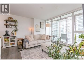 Coquitlam apartment for rent - A living room with a white couch and a large window.