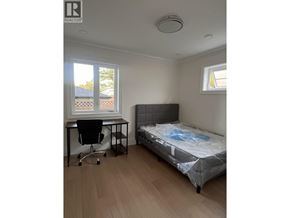 Vancouver apartment for rent - A bedroom with a bed, desk, and chair.