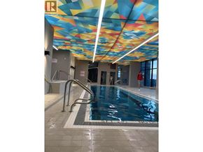 Vancouver apartment for rent - A swimming pool with a diving board and a ceiling with a colorful design.