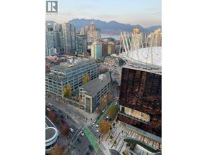 Vancouver apartment for rent - A cityscape with a mountain range in the background and a stadium in the foreground.