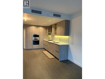 Vancouver apartment for rent - A modern kitchen with wooden cabinets and a central island.
